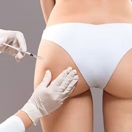 Sculptra butt lifting concept Slim woman having hip injection at beauty salon closeup P